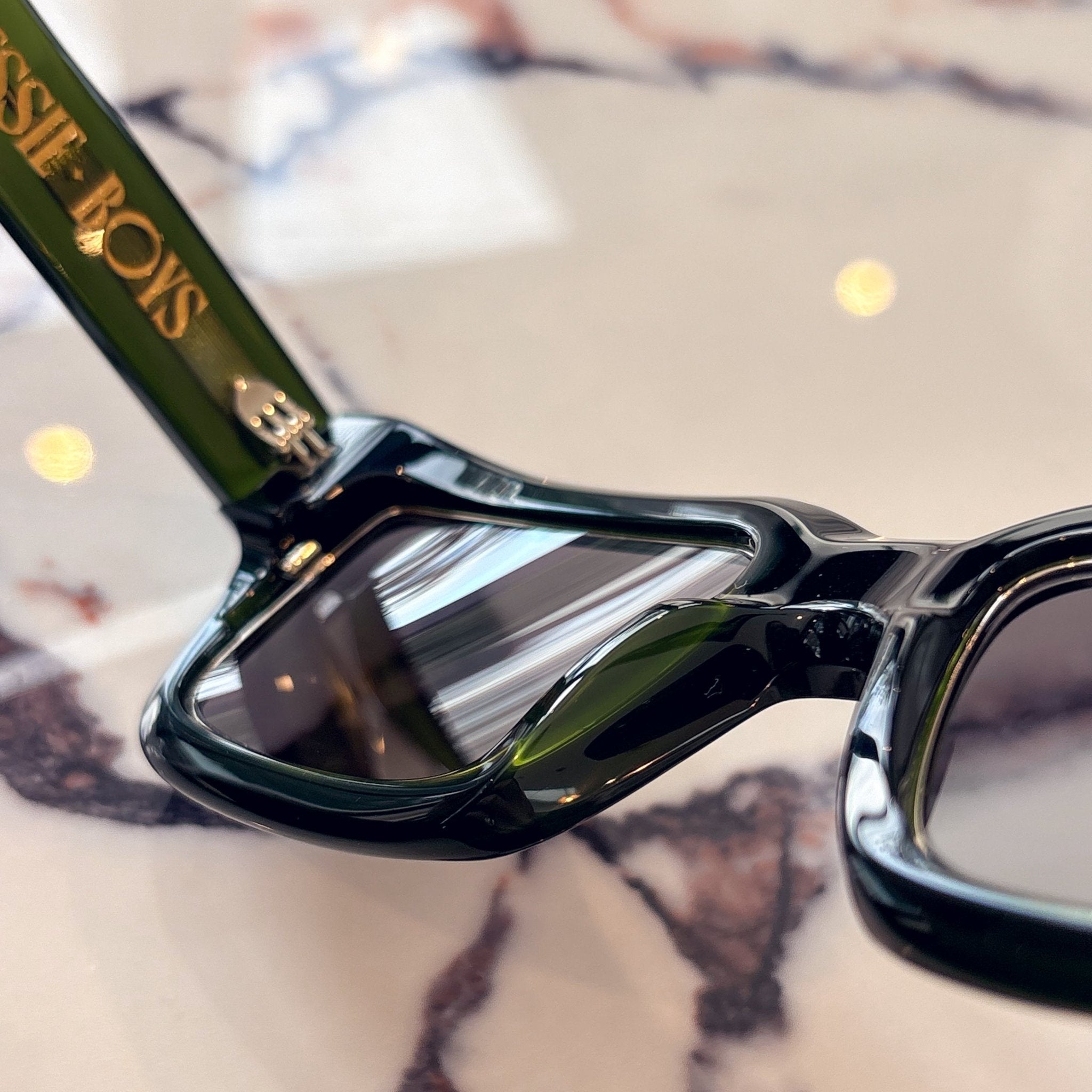 Close-up of Jessie Boys Finchley Cut sunglasses in Regency Green acetate