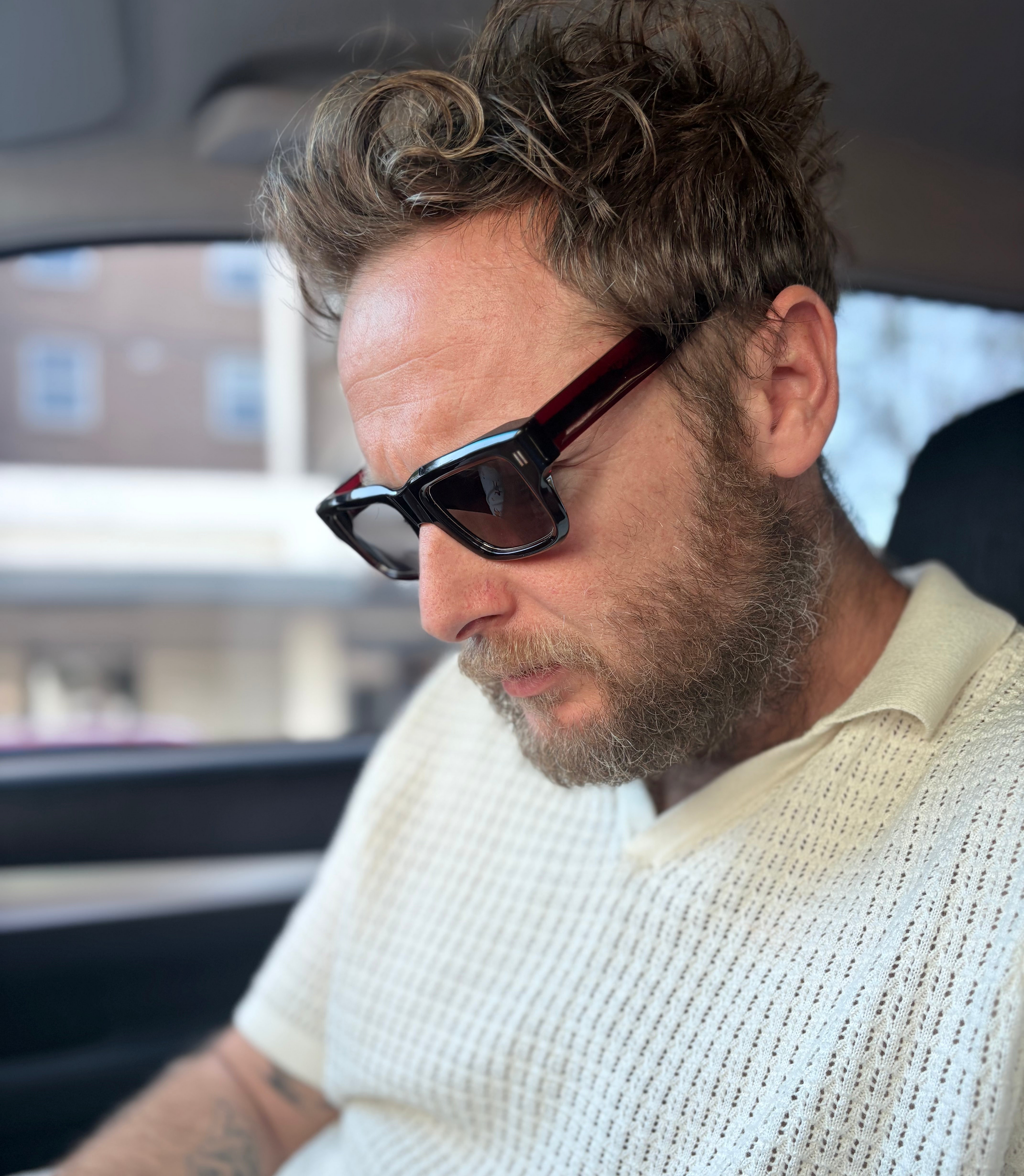 Man wearing Jessie Boys Finchley Cut Oxford Burgundy acetate sunglasses.